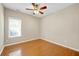 A bright bedroom is naturally lit, with hardwood floors and a ceiling fan at 231 Yardsley Dr, Mcdonough, GA 30253