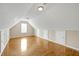 Spacious bonus room with hardwood floors and several storage access doors at 231 Yardsley Dr, Mcdonough, GA 30253