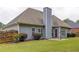 Back exterior elevation features a patio, well-maintained lawn, and mature landscaping at 231 Yardsley Dr, Mcdonough, GA 30253
