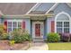 Close-up of the front entrance featuring red shutters, well-kept landscaping and an inviting front door at 231 Yardsley Dr, Mcdonough, GA 30253