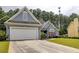 Well-maintained home with an attached two-car garage and a lush green lawn at 231 Yardsley Dr, Mcdonough, GA 30253