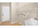 A laundry room with tile floor and overhead storage shelves at 231 Yardsley Dr, Mcdonough, GA 30253
