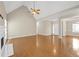 Bright living room with hardwood floors, a fireplace, and open access to dining and entryway at 231 Yardsley Dr, Mcdonough, GA 30253