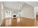 Open-concept living room with hardwood floors, fireplace, and high ceilings at 231 Yardsley Dr, Mcdonough, GA 30253