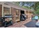 The back of the house features a grill, a TV and outdoor furniture at 286 Indian Trl, Marietta, GA 30068