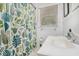 Well-lit bathroom with a patterned shower curtain, white vanity, and classic fixtures at 286 Indian Trl, Marietta, GA 30068