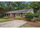 Charming brick home with a well-manicured front yard and a classic brick walkway at 286 Indian Trl, Marietta, GA 30068
