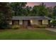 A well maintained brick home featuring an American flag and a manicured lawn at 286 Indian Trl, Marietta, GA 30068