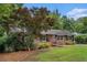 Charming brick home with manicured lawn, mature landscaping, and welcoming front entrance at 286 Indian Trl, Marietta, GA 30068