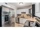 Well-lit kitchen featuring stainless appliances, granite counters, and tile backsplash at 286 Indian Trl, Marietta, GA 30068