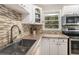 Bright kitchen featuring mosaic backsplash, stainless steel appliances, and white cabinetry at 286 Indian Trl, Marietta, GA 30068