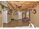Finished basement with exposed ceiling, tiled floor, and seating area for entertainment at 6425 Riley Manor Way, Cumming, GA 30028