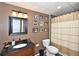 Stylish bathroom with a granite vanity, shower with curtain, and framed mirror at 6425 Riley Manor Way, Cumming, GA 30028