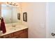 Bathroom featuring a vanity with a sink and a mirror with a black frame at 6425 Riley Manor Way, Cumming, GA 30028
