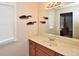Bathroom features a vanity with storage, large mirror, and natural light from the window at 6425 Riley Manor Way, Cumming, GA 30028