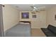 Well-lit bedroom with ceiling fan, sports memorabilia, and sofa offers a cozy space at 6425 Riley Manor Way, Cumming, GA 30028