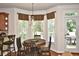 Sunlit breakfast nook featuring a round table and chairs, and views of the outdoors at 6425 Riley Manor Way, Cumming, GA 30028