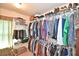 Walk-in closet with ample hanging space and shelving for storage at 6425 Riley Manor Way, Cumming, GA 30028