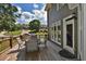 Outdoor deck with chairs and table boasts neighborhood views at 6425 Riley Manor Way, Cumming, GA 30028