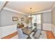 Dining room with hardwood floors, stylish furniture, and bright light at 6425 Riley Manor Way, Cumming, GA 30028