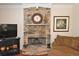 Living room featuring a stone fireplace and hardwood floors at 6425 Riley Manor Way, Cumming, GA 30028