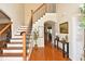 Welcoming foyer with hardwood floors, staircase, and an open view into other rooms at 6425 Riley Manor Way, Cumming, GA 30028