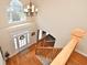Two-story foyer with wood floors and view of the staircase and front door at 6425 Riley Manor Way, Cumming, GA 30028
