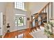 Bright foyer featuring hardwood floors, staircase, and a window above the door for natural light at 6425 Riley Manor Way, Cumming, GA 30028