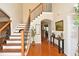 Inviting foyer with hardwood floors, staircase, and decor at 6425 Riley Manor Way, Cumming, GA 30028