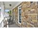 Inviting front porch featuring rocking chairs and stone detailing at 6425 Riley Manor Way, Cumming, GA 30028