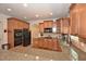 Spacious kitchen with granite countertops, wood cabinetry, and stainless steel appliances at 6425 Riley Manor Way, Cumming, GA 30028