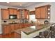Well-lit kitchen with wooden cabinets, granite countertops and stainless steel appliances at 6425 Riley Manor Way, Cumming, GA 30028