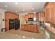 Spacious kitchen features granite countertops, wooden cabinets, and stainless steel appliances at 6425 Riley Manor Way, Cumming, GA 30028