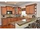 Well-equipped kitchen with granite countertops, stainless steel appliances, and wood cabinets at 6425 Riley Manor Way, Cumming, GA 30028