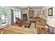 Comfortable living room with hardwood floors, stone fireplace, and ample seating at 6425 Riley Manor Way, Cumming, GA 30028