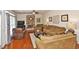Cozy living room with a stone fireplace, hardwood floors, and lots of comfortable seating at 6425 Riley Manor Way, Cumming, GA 30028