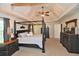 Spacious main bedroom features a tray ceiling, a four-poster bed, and ample closet space at 6425 Riley Manor Way, Cumming, GA 30028