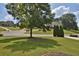 Residential neighborhood featuring well-maintained homes and green spaces under a sunny sky at 6425 Riley Manor Way, Cumming, GA 30028