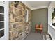 Cozy porch showcasing stone wall, white trim, and birdhouses for a charming touch at 6425 Riley Manor Way, Cumming, GA 30028