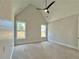 Bright bedroom with vaulted ceiling features light gray walls, two large windows, and a modern ceiling fan at 115 Palisade Dr, Rydal, GA 30171
