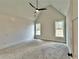 Vaulted ceiling bedroom has light gray walls, two large windows, and a ceiling fan, creating a bright and comfortable space at 115 Palisade Dr, Rydal, GA 30171