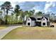 Elegant two-story home features white siding and brick, black accents, and a well-manicured lawn at 115 Palisade Dr, Rydal, GA 30171
