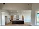 Open-concept kitchen with white cabinetry, dark countertops, a large island, and modern lighting at 115 Palisade Dr, Rydal, GA 30171