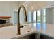 Modern kitchen featuring a gooseneck faucet, stone fireplace and light-filled open concept at 115 Palisade Dr, Rydal, GA 30171