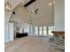 Bright, open-concept living area featuring high ceilings, a fireplace, and wood floors at 115 Palisade Dr, Rydal, GA 30171