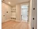 Inviting mudroom with storage and built-in bench with view to the laundry room at 115 Palisade Dr, Rydal, GA 30171