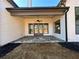 Covered patio with stone floor, ceiling fan, and access to the backyard at 115 Palisade Dr, Rydal, GA 30171