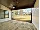Covered outdoor patio featuring stone flooring, a ceiling fan, and views of the green backyard at 115 Palisade Dr, Rydal, GA 30171