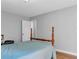 Bedroom featuring a wooden-framed bed with light blue covers and a view of the neutral-colored walls at 190 Crestworth Ct, Powder Springs, GA 30127
