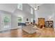 Spacious living room featuring high ceilings, a fireplace, hardwood floors, and natural light at 190 Crestworth Ct, Powder Springs, GA 30127